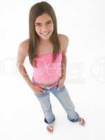 Young girl standing with hands on hips smiling