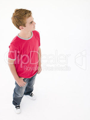 Teenage boy with hands in pockets