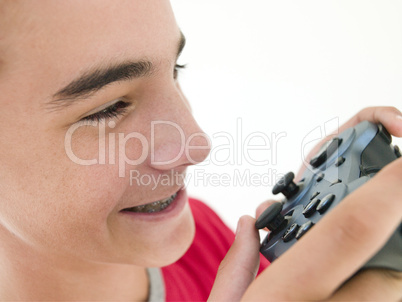 Teenage boy using videogame controller