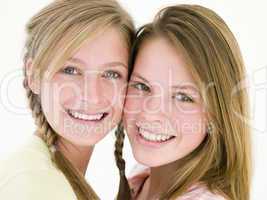 Two girl friends together smiling