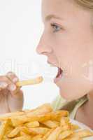 Teenage girl eating French fries