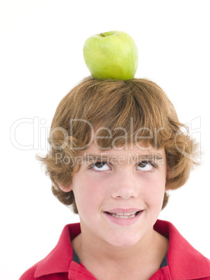 Young boy with apple on his head smiling