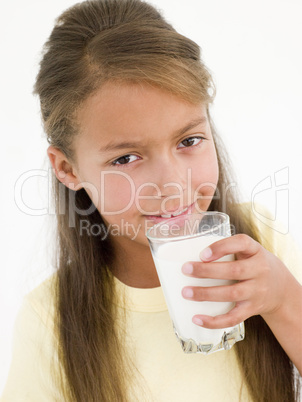 Young girl drinking glass of milk