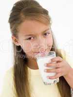 Young girl drinking glass of milk