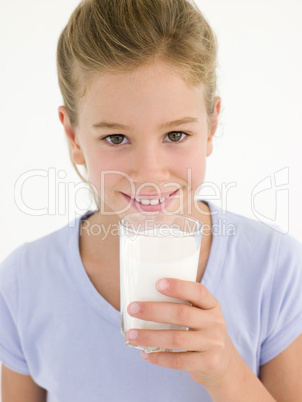 Young girl with glass of milk smiling