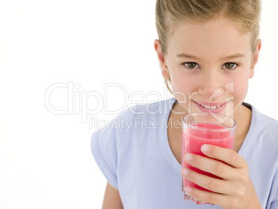 Young girl with glass of juice smiling