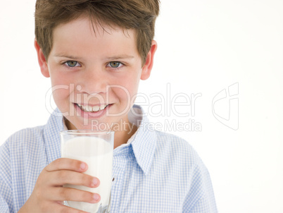 Young boy with glass of milk smiling