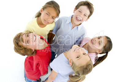 Circle of five young friends smiling