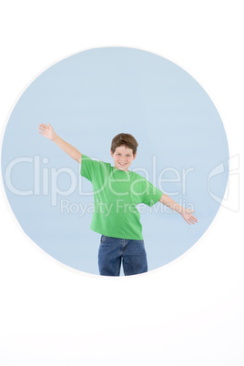 Young boy standing with arms out smiling