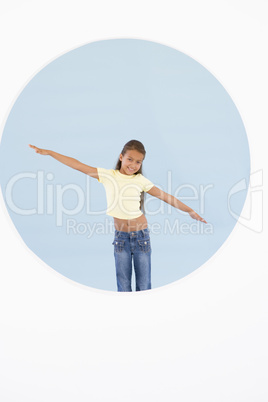 Young girl standing with arms out smiling