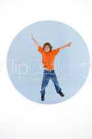 Young boy jumping with arms out smiling