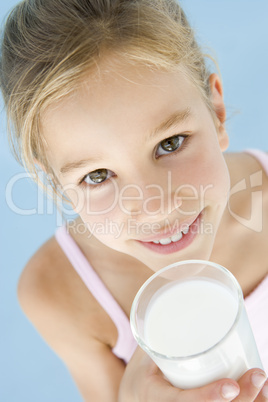 Young girl with glass of milk smiling