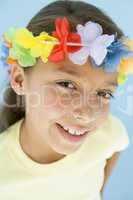 Young girl wearing garland on head smiling