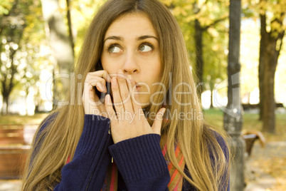 Attractive girl in the autumn on the phone