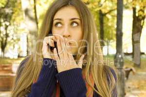 Attractive girl in the autumn on the phone