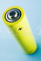 A Yellow Battery Against A Blue Background