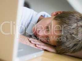 Young Boy Asleep By His Laptop