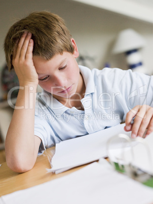 Young Boy Doing Homework In His Room