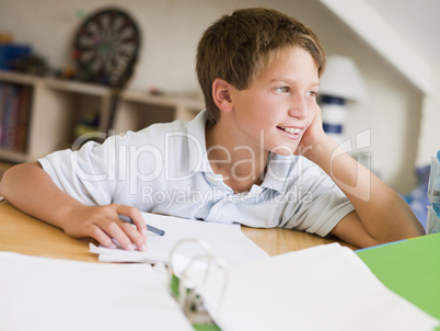 Young Boy Doing Homework In His Room