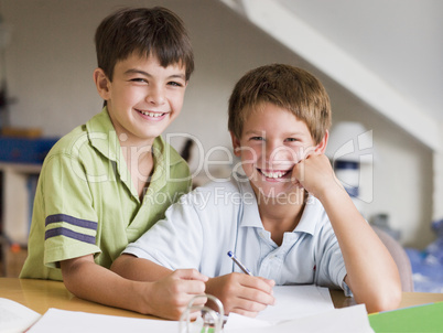 Two Young Boys Doing Their Homework Together