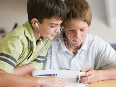 Two Young Boys Distracted From Their Homework, Playing With An M