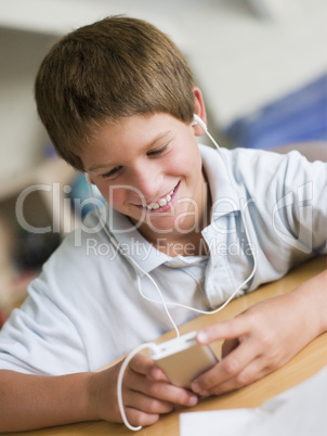 Young Boy  Playing With An MP3 Player