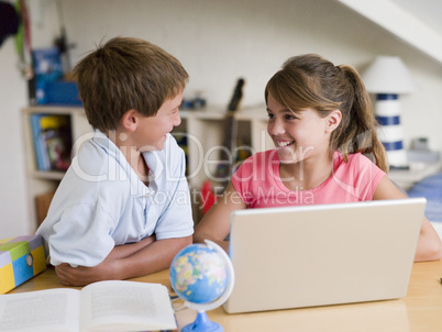 Boy And Girl Doing Their Homework On A Laptop