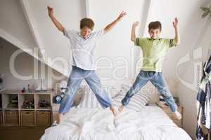 Young Boys Jumping On Bed