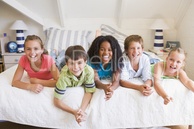 Five Young Friends Lying Down Next To Each Other