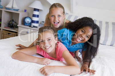 Three Young Friends Lying On Top Of Each Other