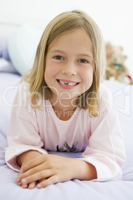 Young Girl Lying On Her Bed In Her Pajamas