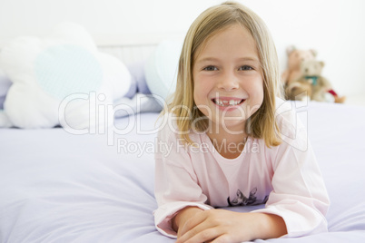 Young Girl Lying On Her Bed In Her Pajamas