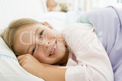 Young Girl Lying Down In Her Bed