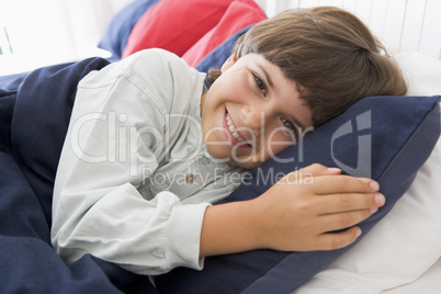 Young Boy Lying Down In His Bed