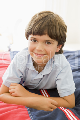 Young Boy Lying Down On His Bed