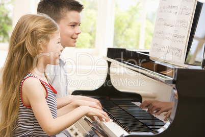 Brother And Sister Playing Piano