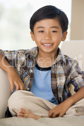 Young Buy Sitting On A Sofa At Home