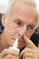 Senior Man Using Nasal Spray