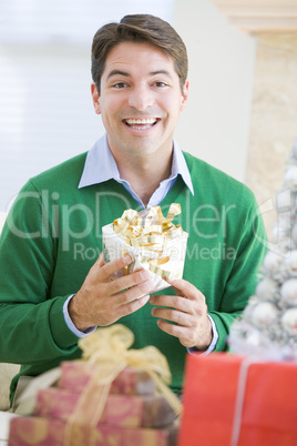 Man Excited To Open Christmas Present