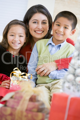 Mother With Her Daughter And Son Holding Christmas Gifts