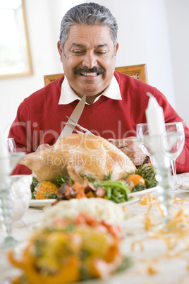 Senior Man Excitedly Getting Ready To Carve The Turkey