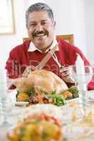 Senior Man Excitedly Getting Ready To Carve The Turkey