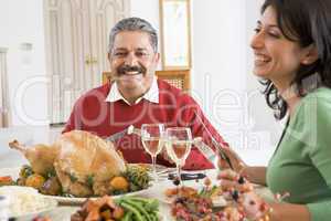 Father And His Adult Daughter Sitting Down For Christmas Dinner