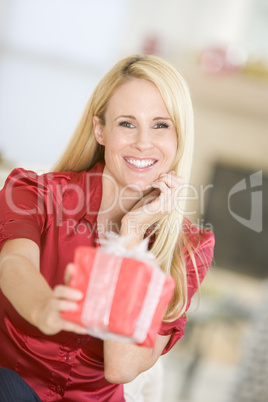 Woman Handing Out Christmas Present