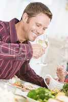 Man Drinking Wine At Christmas Dinner