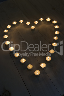 Illuminated Candles Placed In A Heart Shape