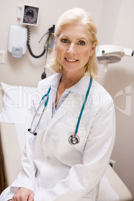 Middle Aged Female Doctor Sitting In A Hospital Ward