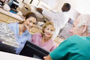 Nurses Talking At The Reception Area In A Hospital