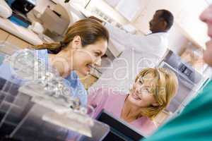 Nurses Talking At The Reception Area In A Hospital