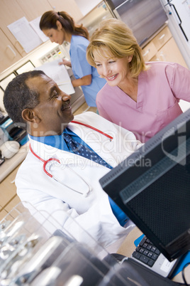 A Doctor And Nurse Discussing Something At The Reception Area Of